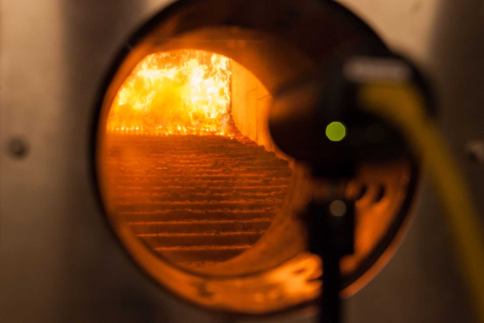 Wood chips burn in a furnace of co-generation plant