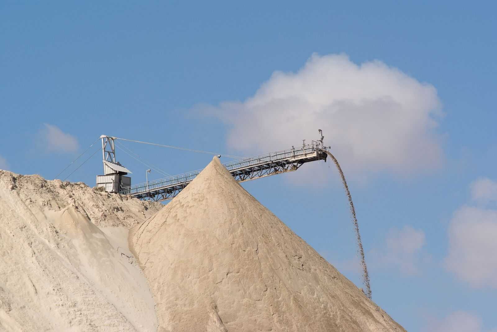 Crushed stone pouring off an elevated conveyor onto a large pile